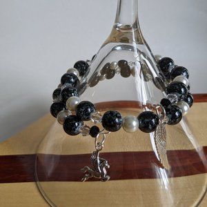 Black and pearl beaded memory wire bracelet with silver charms